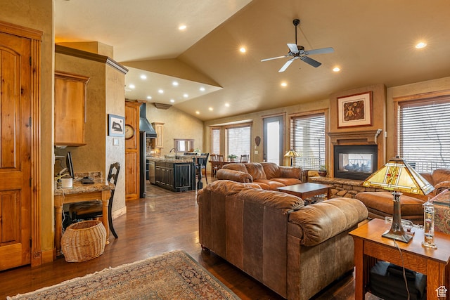 living room with lofted ceiling, recessed lighting, dark wood finished floors, ceiling fan, and a multi sided fireplace