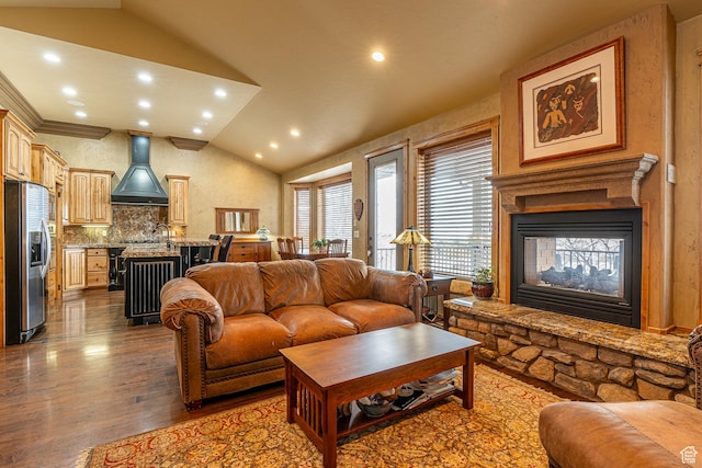 living area with recessed lighting, a multi sided fireplace, lofted ceiling, and dark wood-style floors