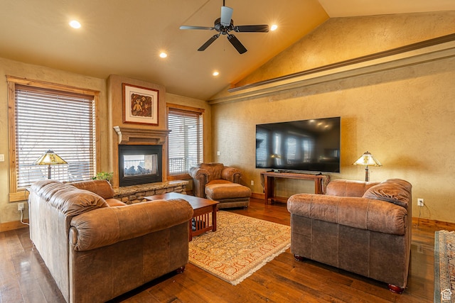 living area featuring hardwood / wood-style flooring, recessed lighting, ceiling fan, a textured wall, and a multi sided fireplace