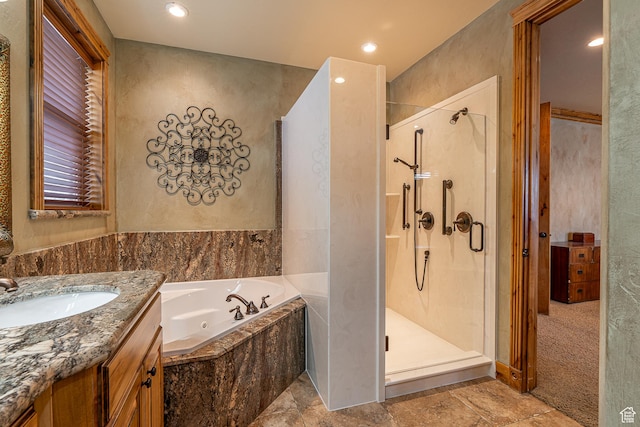 full bath featuring a tub with jets, vanity, a shower stall, and recessed lighting