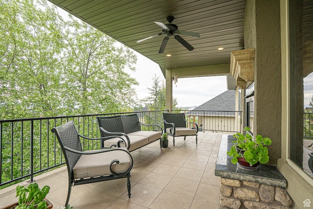 view of patio with ceiling fan and a balcony