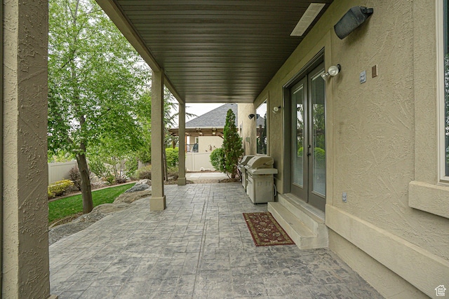 view of patio / terrace featuring fence, area for grilling, and french doors