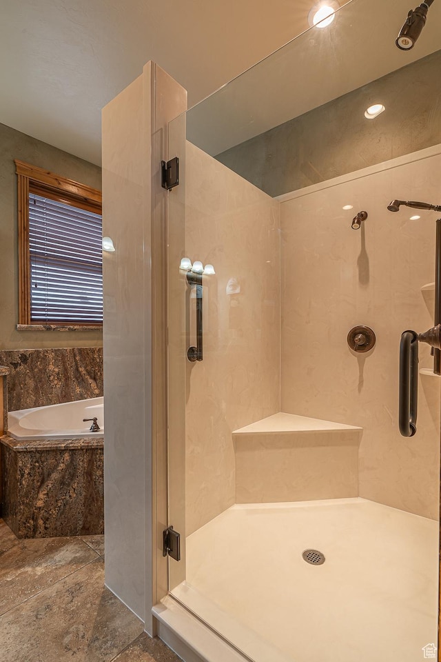 bathroom with a stall shower, a garden tub, and recessed lighting