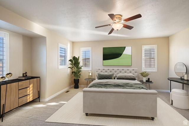 bedroom featuring light colored carpet, a textured ceiling, baseboards, and ceiling fan