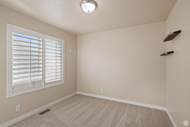 unfurnished room featuring visible vents, baseboards, and carpet floors