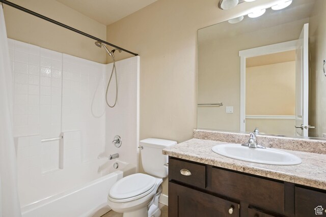 bathroom featuring toilet, vanity, and tub / shower combination