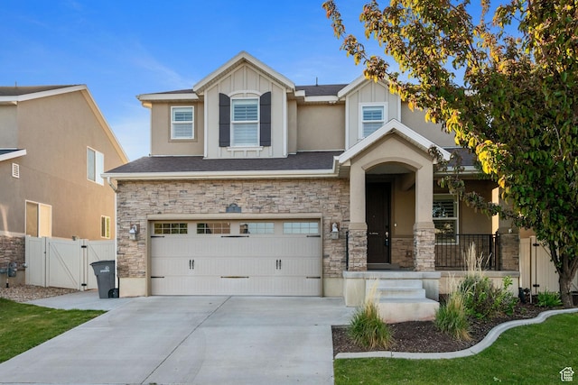 11122 S Broadwick Rd W, South Jordan, UT 84095 - view of front of home featuring a garage, driveway, a gate, and stone siding