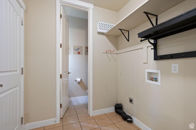 clothes washing area featuring baseboards, hookup for a washing machine, light tile patterned flooring, laundry area, and electric dryer hookup