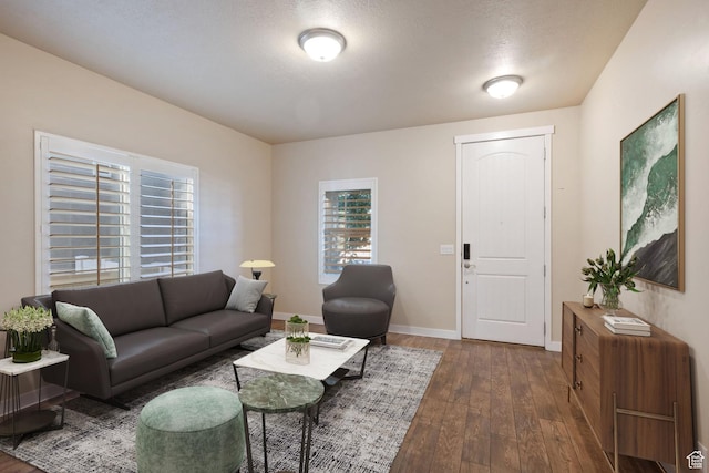 living area with baseboards and hardwood / wood-style floors