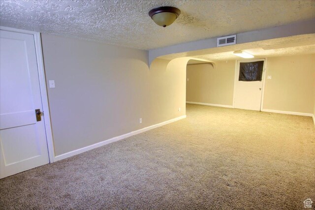 3417 S Lincoln Ave, Ogden, UT 84401 - finished below grade area with carpet floors, baseboards, a textured ceiling, and arched walkways