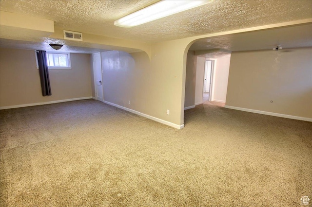 3417 S Lincoln Ave, Ogden, UT 84401 - unfurnished room with a textured ceiling, carpet flooring, baseboards, and arched walkways