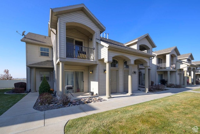 474 S 2550 W Unit 2, Springville, UT 84663 - view of front of house with fence, a front yard, and a balcony