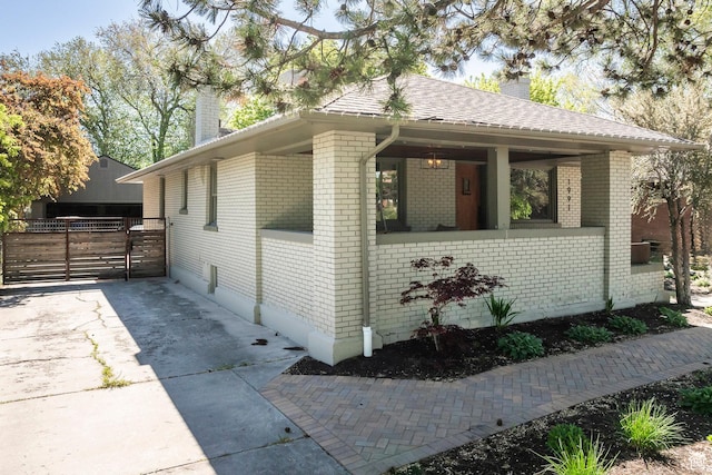1991 S 800 E, Salt Lake City, UT 84105 - view of side of home with brick siding, roof with shingles, a chimney, and fence