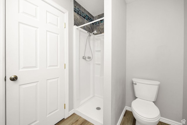 736 Majestic Dr, Logan, UT 84321 - full bath with wood finished floors, a shower stall, baseboards, and toilet