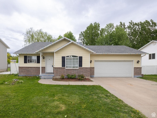 736 Majestic Dr, Logan, UT 84321 - single story home with brick siding, an attached garage, concrete driveway, and a front lawn