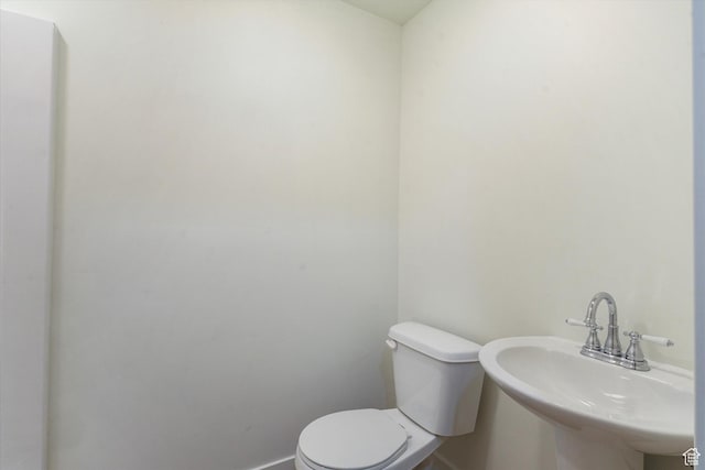251 Sunstone Cir, Logan, UT 84321 - bathroom with baseboards, toilet, and a sink
