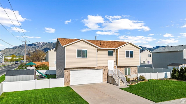 251 Sunstone Cir, Logan, UT 84321 - split foyer home featuring a mountain view, brick siding, and fence