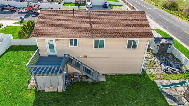 251 Sunstone Cir, Logan, UT 84321 - back of house featuring a yard, a deck, stairway, a fenced backyard, and a storage unit