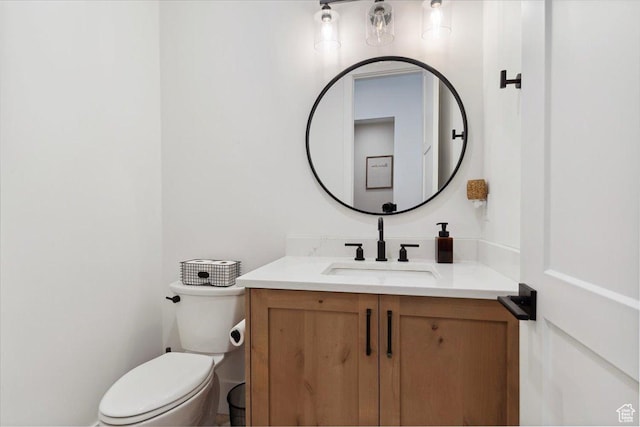 half bathroom with toilet and vanity