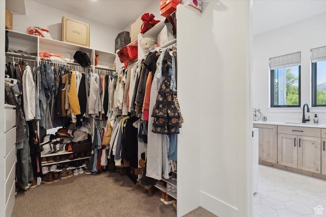 walk in closet featuring a sink