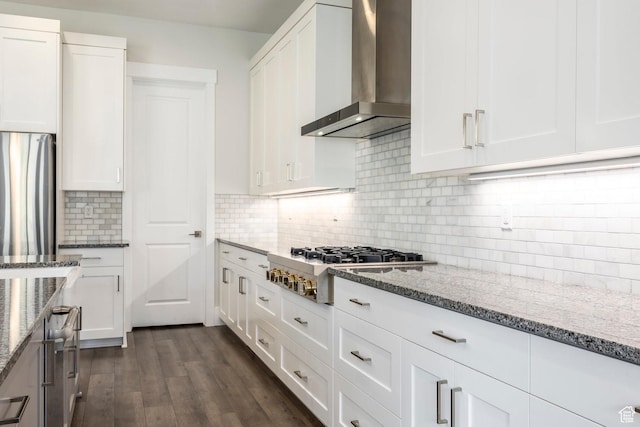9293 S Regatta Ln, Cottonwood Heights, UT 84093 - kitchen with white cabinetry, light stone counters, stainless steel appliances, and wall chimney exhaust hood