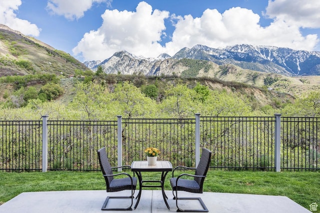 9293 S Regatta Ln, Cottonwood Heights, UT 84093 - view of patio featuring fence, outdoor dining area, and a mountain view