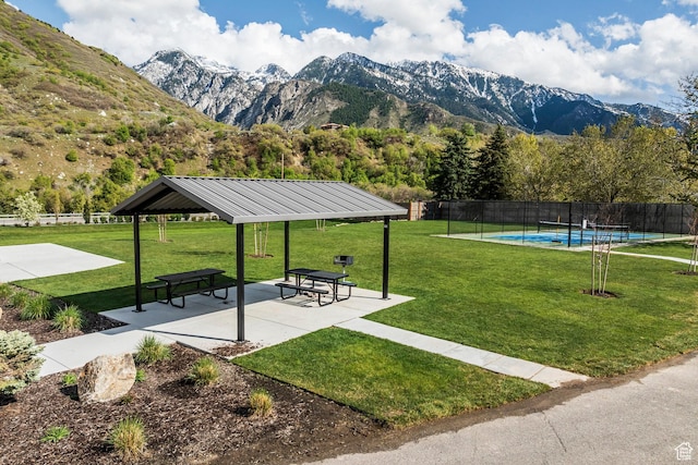 9293 S Regatta Ln, Cottonwood Heights, UT 84093 - view of home's community with a mountain view, a swimming pool, fence, a gazebo, and a yard