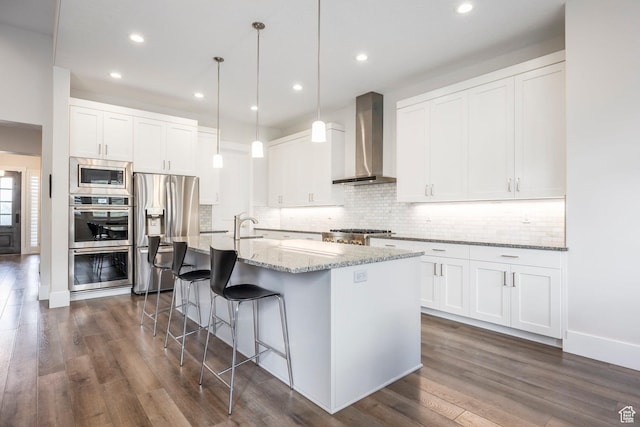 9293 S Regatta Ln, Cottonwood Heights, UT 84093 - kitchen with dark wood-style flooring, decorative backsplash, wall chimney exhaust hood, a center island with sink, and stainless steel appliances