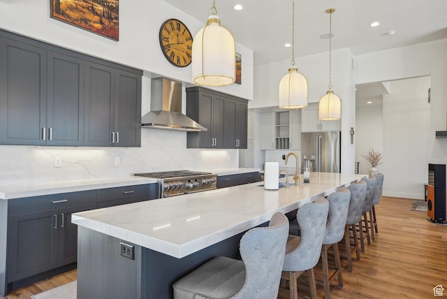 11332 N White Tail Ct Unit 30, Hideout, UT 84036 - kitchen with light wood finished floors, a sink, high end appliances, wall chimney exhaust hood, and light stone counters