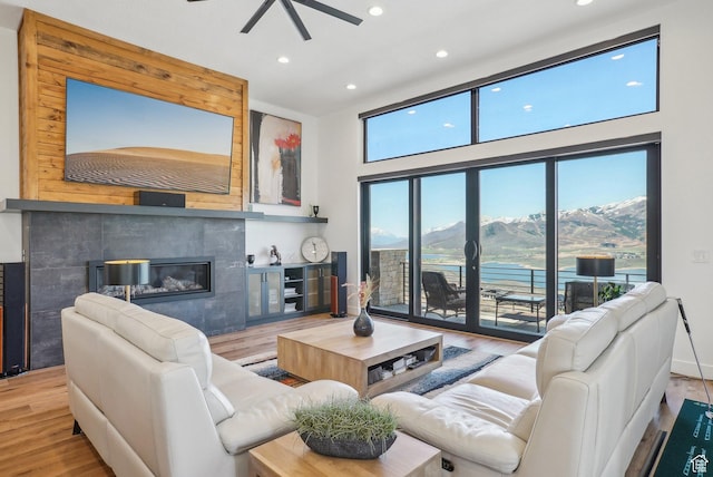 11332 N White Tail Ct Unit 30, Hideout, UT 84036 - living area featuring a ceiling fan, recessed lighting, a mountain view, a tiled fireplace, and wood finished floors
