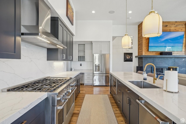 11332 N White Tail Ct Unit 30, Hideout, UT 84036 - kitchen featuring light stone countertops, light wood finished floors, a sink, high end appliances, and wall chimney range hood