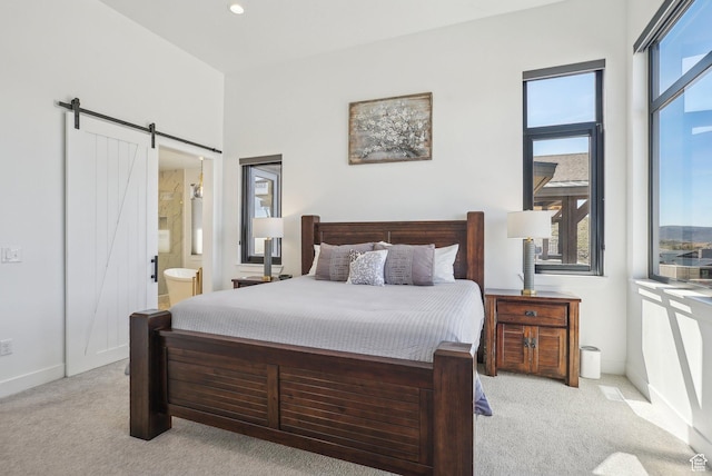 11332 N White Tail Ct Unit 30, Hideout, UT 84036 - carpeted bedroom featuring baseboards, connected bathroom, and a barn door