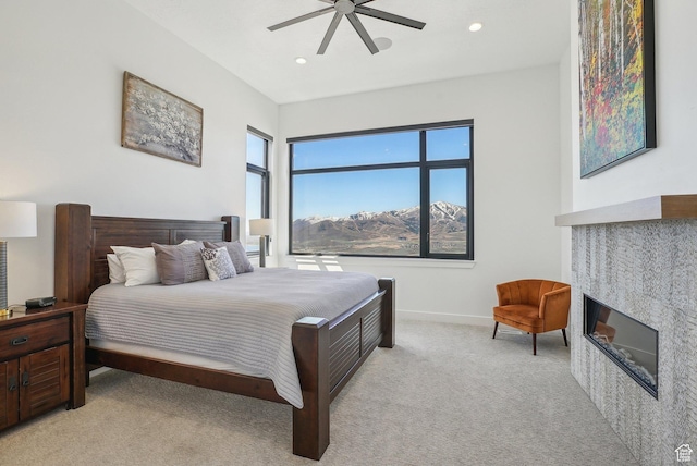 11332 N White Tail Ct Unit 30, Hideout, UT 84036 - bedroom with recessed lighting, baseboards, a tiled fireplace, ceiling fan, and light colored carpet