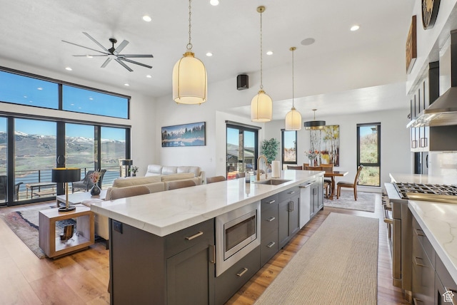 11332 N White Tail Ct Unit 30, Hideout, UT 84036 - kitchen featuring a sink, a healthy amount of sunlight, open floor plan, appliances with stainless steel finishes, and recessed lighting