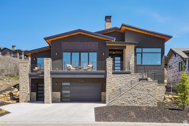 11332 N White Tail Ct Unit 30, Hideout, UT 84036 - contemporary house with an attached garage, stone siding, a balcony, concrete driveway, and a chimney