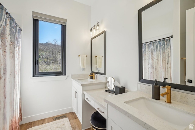 11332 N White Tail Ct Unit 30, Hideout, UT 84036 - bathroom with visible vents, wood finished floors, two vanities, and a sink