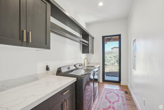 11332 N White Tail Ct Unit 30, Hideout, UT 84036 - laundry area with independent washer and dryer, baseboards, visible vents, wood finished floors, and cabinet space