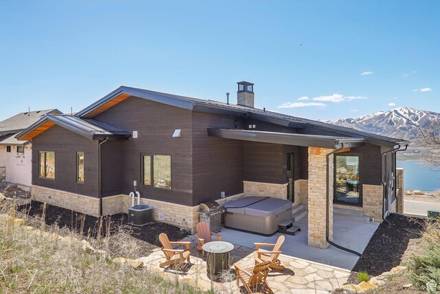 11332 N White Tail Ct Unit 30, Hideout, UT 84036 - back of house featuring a chimney, a patio area, a hot tub, and stone siding