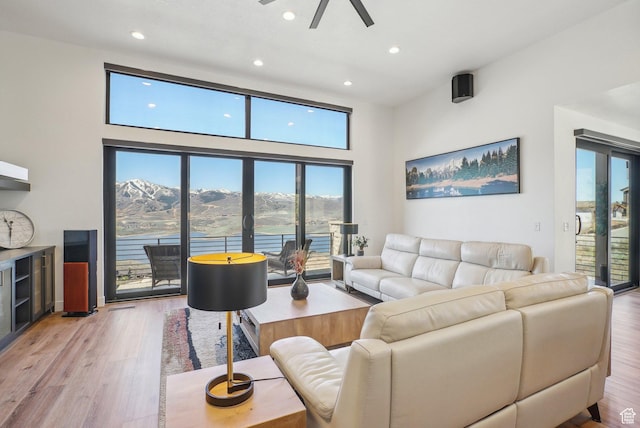 11332 N White Tail Ct Unit 30, Hideout, UT 84036 - living room with recessed lighting, a mountain view, light wood finished floors, ceiling fan, and a towering ceiling