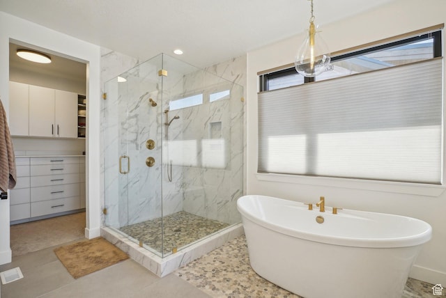 11332 N White Tail Ct Unit 30, Hideout, UT 84036 - full bath featuring a freestanding bath, a marble finish shower, a healthy amount of sunlight, and tile patterned flooring