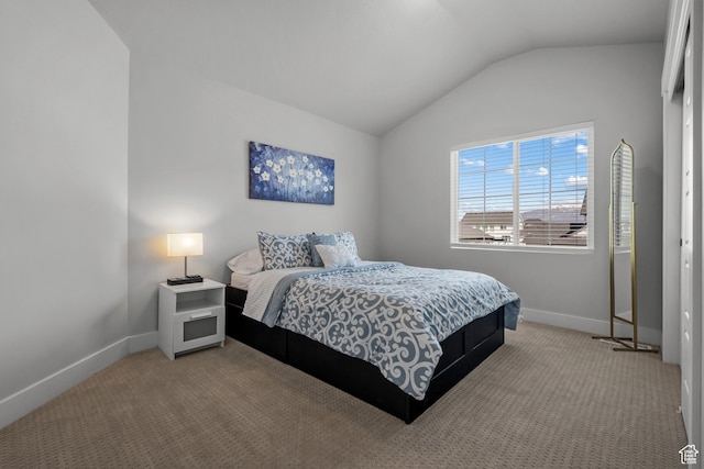 bedroom featuring lofted ceiling, baseboards, and carpet floors