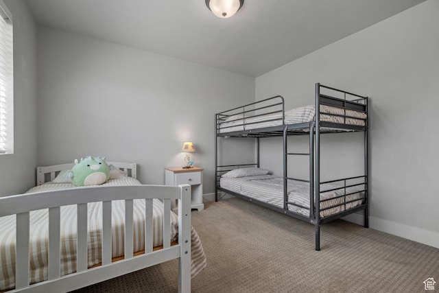 bedroom with carpet flooring and baseboards