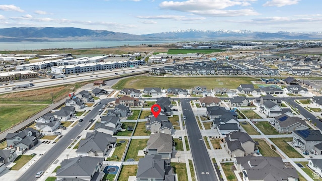 drone / aerial view featuring a water and mountain view