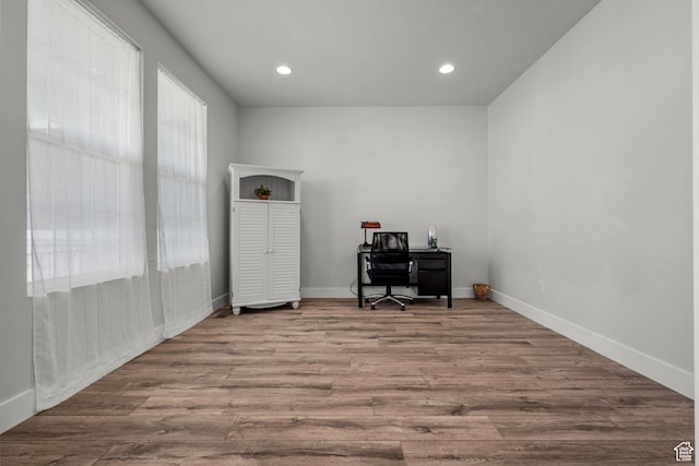 home office featuring wood finished floors, baseboards, and recessed lighting