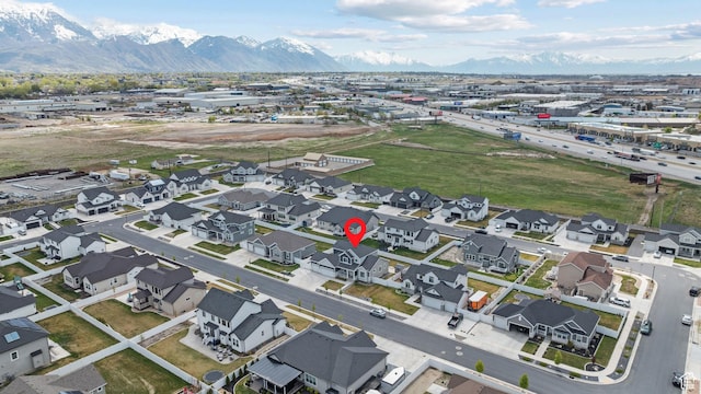 drone / aerial view featuring a residential view and a mountain view