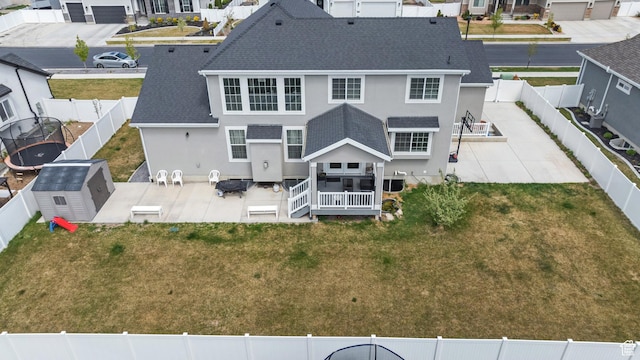 back of house featuring a patio, stucco siding, a fenced backyard, and a residential view