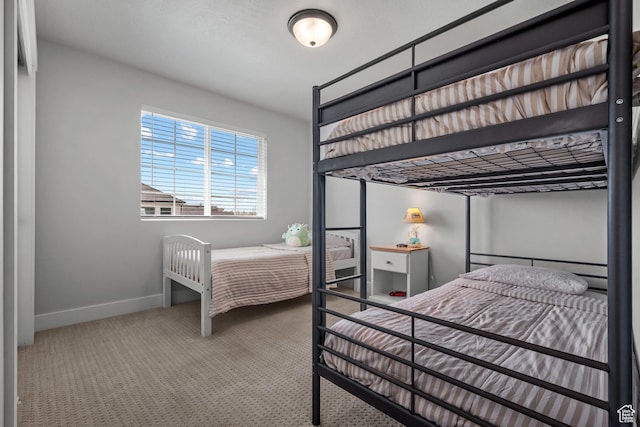 carpeted bedroom with baseboards