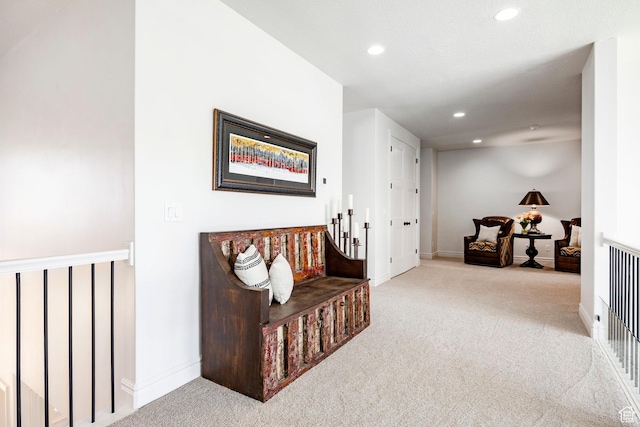 sitting room with carpet, recessed lighting, baseboards, and an upstairs landing