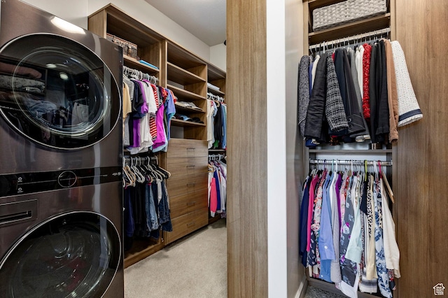 washroom featuring stacked washer and clothes dryer and carpet flooring