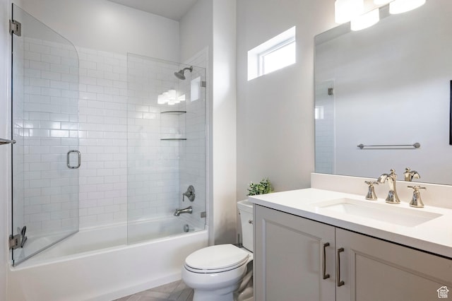 full bathroom with toilet, enclosed tub / shower combo, and vanity